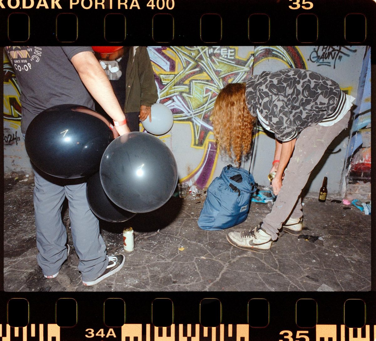 A dealer in downtown Los Angeles distributes nitrous oxide balloons to buyers. 
