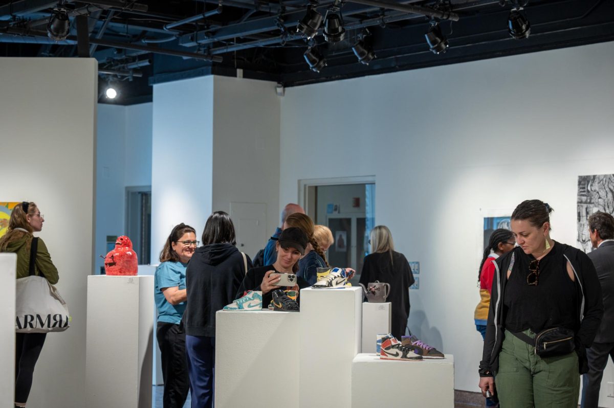 Gallery attendees viewing the different works in ceramics, painting, printmaking, sculpture, photography, and graphic design made by Valley Art students at the Annual Art Student invitational reception.