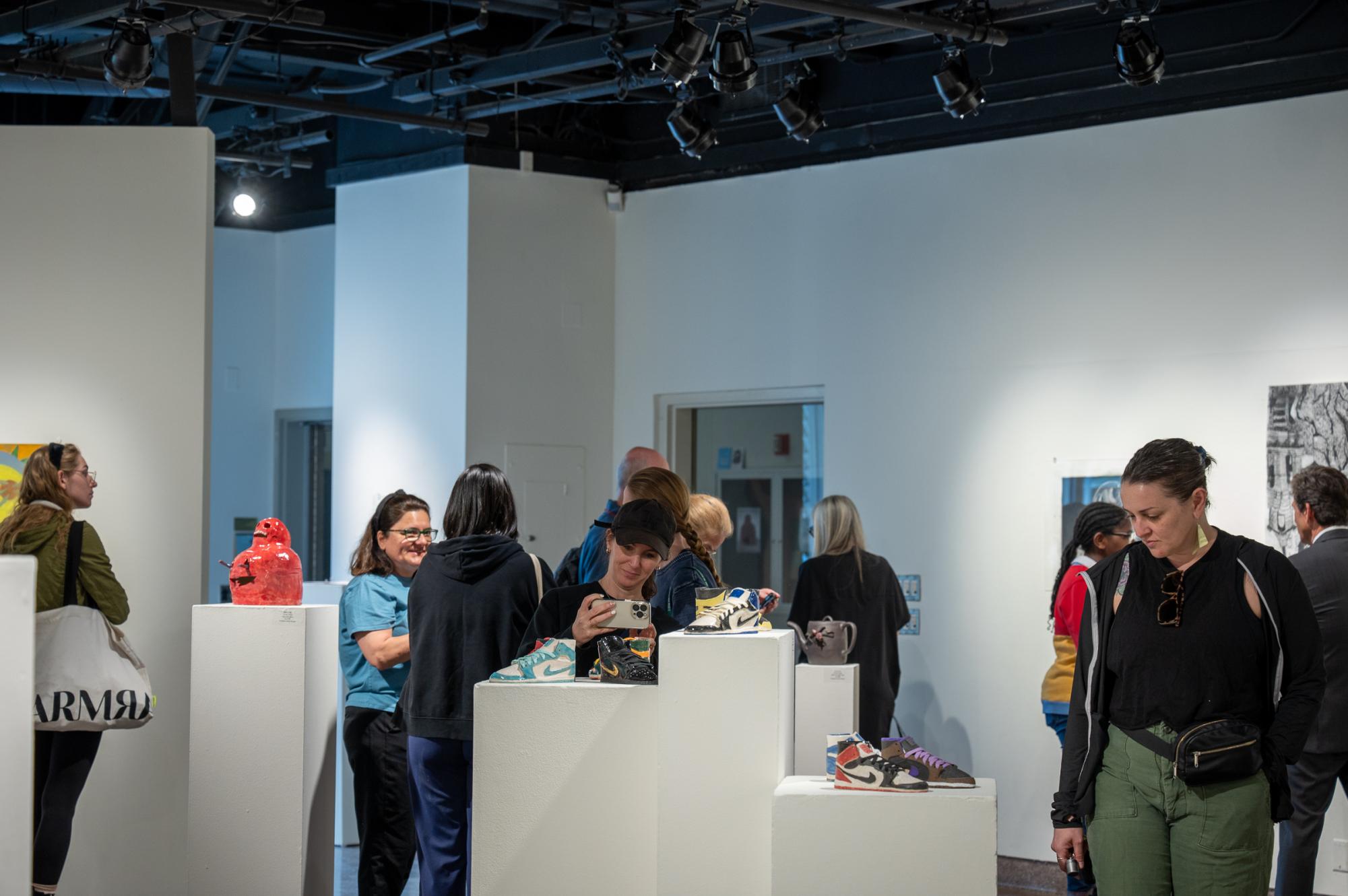 Gallery attendees viewing the different works in ceramics, painting, printmaking, sculpture, photography, and graphic design made by Valley Art students at the Annual Art Student invitational reception. 
