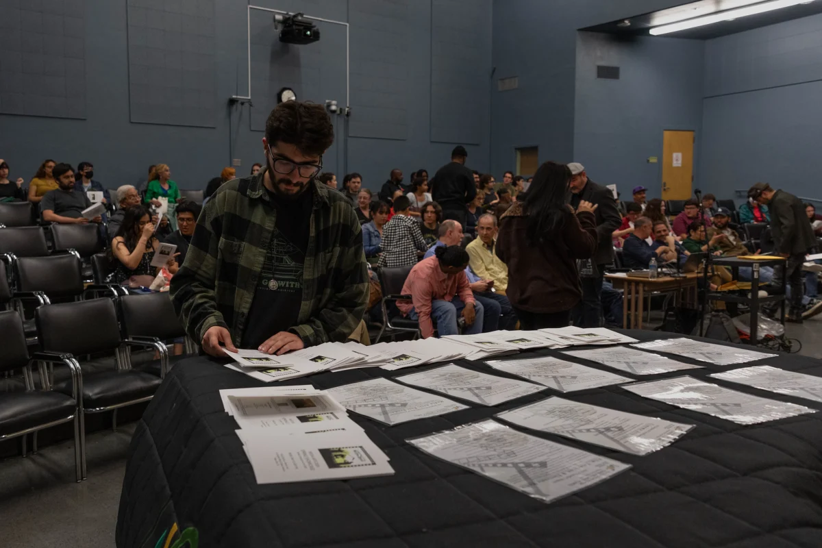 Student Artavazd Ovakimyan seeks through the LAVC Media Arts Student Showcase Spring pamphlets moments before the showing of student films.  